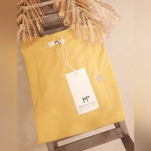 Pullover yellow sweater with a charm on left chest